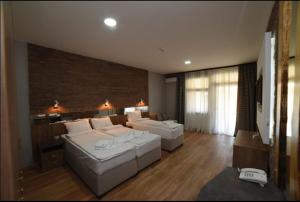 a living room with two white couches at Konak Koliba in Leskovac