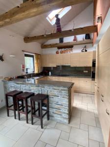 a kitchen with two stools and a bar in a room at Maboge 20C in La Roche-en-Ardenne