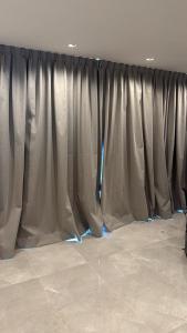 a table with a curtain in a room at Catalina Hotel in Yerba Buena