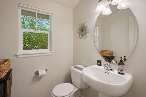 a bathroom with a toilet and a sink and a mirror at Old Mill Magic in Bend +30 photos