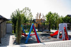 a playground with two play equipment in a yard at Chuxuryurd Hotel in Shamakhi
