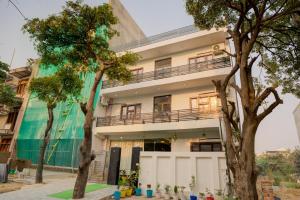 a building with trees in front of it at Amara Inn in Greater Noida