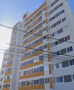 a tall apartment building with a street light in front of it at Estrela Da Manhã Flat in Brasilia +6 photos
