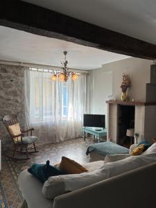 a living room with a couch and a fireplace at Spacious Village House in Ginoles with Garden in Ginoles