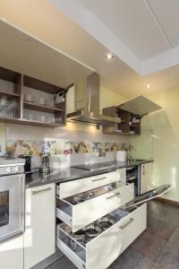 a kitchen with white cabinets and stainless steel appliances at Elite centre, free parking, ultra-desirable 1 of 1, lux view in Rīga