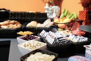 a table topped with baskets of different types of food at Maverick Athenaeum in Budapest +47 photos