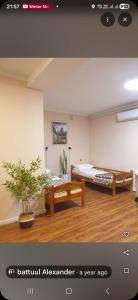 a room with a bed and a couch in a room at Bee Happy Hostel & Gobi amazing tour in Dalandzadgad