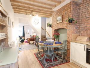 a kitchen and dining room with a brick wall at Derwen House in Llangollen