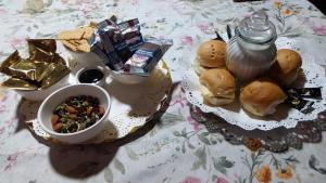 a table topped with a plate of food with sandwiches and snacks at Hospedaje con Pensión Completa in Angol
