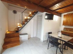a kitchen with a staircase and a table and chairs at Le coste sul lago in Montefiascone +25 photos