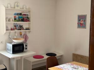 a small kitchen with a microwave on a table at Haus Betty in Rattelsdorf