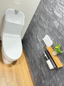 a bathroom with a white toilet in a room at OmOTeNaShI YAHIRO in Tokyo