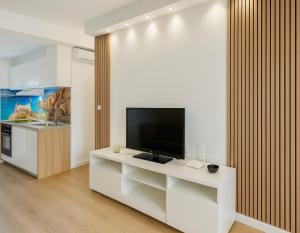 a living room with a television on a white cabinet at SANTA BEACH in Roses