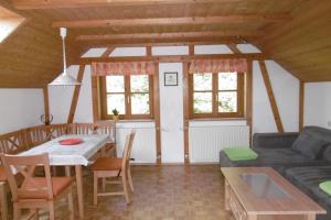 a living room with a table and a couch at Ferienwohnung Friesenhof Blank In Sulzberg in Sulzberg +12 photos
