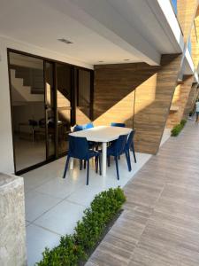 a white table and chairs on a patio at Casa em condomínio na praia in Cabedelo