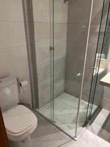 a shower stall in a bathroom with a toilet at Casa em condomínio na praia in Cabedelo
