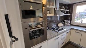 a kitchen with a stainless steel stove top oven at PUNTA MOGOTES Hermosa vista almar in Mar del Plata
