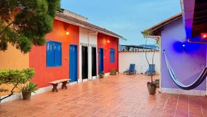 a building with colorful walls and a patio with a bench at Vila Santê in Belo Horizonte