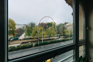 a window view of a city with a ferris wheel at SasOne & Sas Two & Sas HO in Budapest