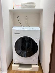 a washer and dryer in a small room at OmOTeNaShI YAHIRO in Tokyo +12 photos