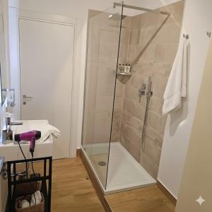 a shower with a glass door in a bathroom at Etna Charme Guest House in Belpasso +5 photos