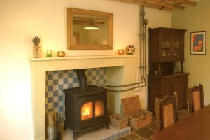 a living room with a fireplace and a mirror at Charente Cozy Family Winter Retreat in Theil-Rabier