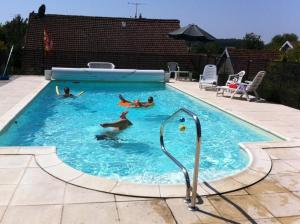a group of people swimming in a swimming pool at Steinhaus In Ländlicher Umgebung Mit Pool in Brotte-lès-Ray