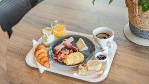 a tray of breakfast food on a table at KYRIAD DAX - Saint Paul lès Dax in Saint-Paul-lès-Dax