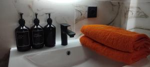 a bathroom with two bottles of wine on a sink at Однокомнатная квартира посуточно in Astana