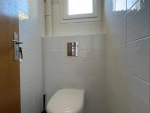 a bathroom with a toilet and a window at Appartement 2 pièces, 4 pers, balcon, parking, sauna - FR-1-263-87 in Valloire +9 photos