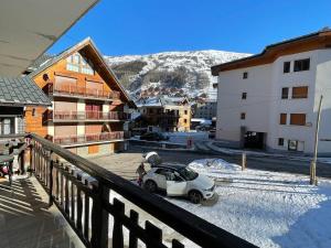 a white car parked on a balcony of a building at Appartement 2 pièces, 4 pers, balcon, parking, sauna - FR-1-263-87 in Valloire