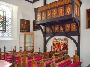 a church with a large wooden pulpit and a altar at The Friars Apartment, Eastbridge Hospital in Canterbury