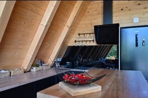 a kitchen with a counter with a bowl of flowers on a table at 2 Bedroom Holiday Home in Topusko +22 photos