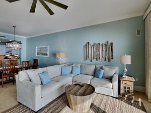 a living room with a white couch and blue walls at Adagio #203A in Santa Rosa Beach