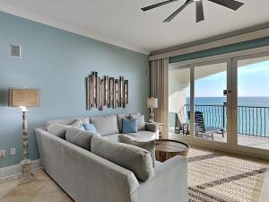 a living room with a couch and a view of the ocean at Adagio #203A in Santa Rosa Beach