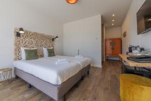 Postel nebo postele na pokoji v ubytování Strandhotel Dennenbos