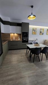 a kitchen with a table and chairs in a room at Kalpazo Tirana Mosaic in Tirana +16 photos