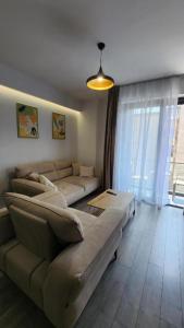 a living room with a couch and a table at Kalpazo Tirana Mosaic in Tirana