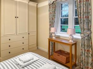 Ένα ή περισσότερα κρεβάτια σε δωμάτιο στο Baldowrie Lodge