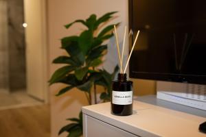 a bottle of wine sitting on a desk with bamboo sticks in it at New Downtown Retreat in Akureyri