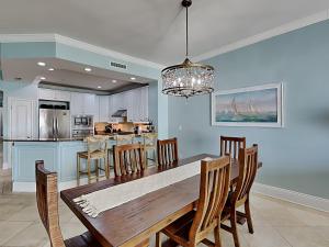 a dining room and kitchen with a table and chairs at Adagio #203A in Santa Rosa Beach +37 photos