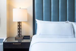 una camera da letto con un letto e una lampada sul comodino di The Marc Hotel a Milwaukee