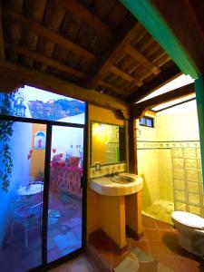 a bathroom with a sink and a toilet at Casa de los Santos in Guanajuato