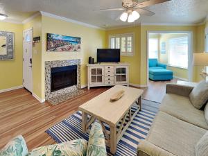 a living room with a couch and a fireplace at Seaside Delight in Mustang Beach