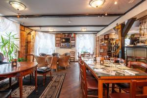 a dining room with wooden tables and chairs at Kjøbmandsgaarden Hotel in Mandal