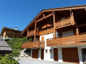 a building with wooden balconies on the side of it at Chalet confortable 6 pers, 3 ch, à côté des pistes La Balme/Fernuy - FR-1-304-291 in La Clusaz