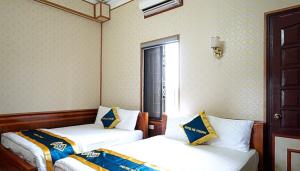 Ένα ή περισσότερα κρεβάτια σε δωμάτιο στο Hà Thành Motel Bắc Ninh