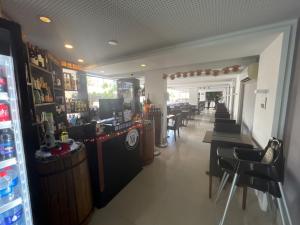 a restaurant with a bar and some tables and chairs at Gold Flat Cabo Branco in João Pessoa
