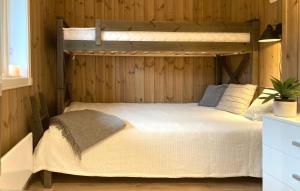 a bedroom with a bunk bed in a wooden wall at Apartment in Gol Skisenter in Gol