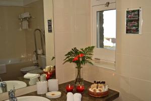 ein Badezimmer mit Waschbecken und einer Blumenvase in der Unterkunft Ferienhaus für 3 Personen ca 60 m in Nordestinho, Azoren Sao Miguel in Nordestinho + 23 Fotos